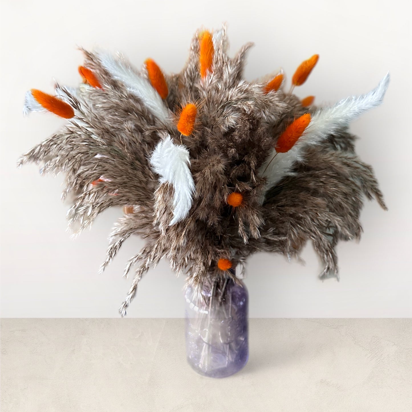 Dried floral arrangements with glass vase