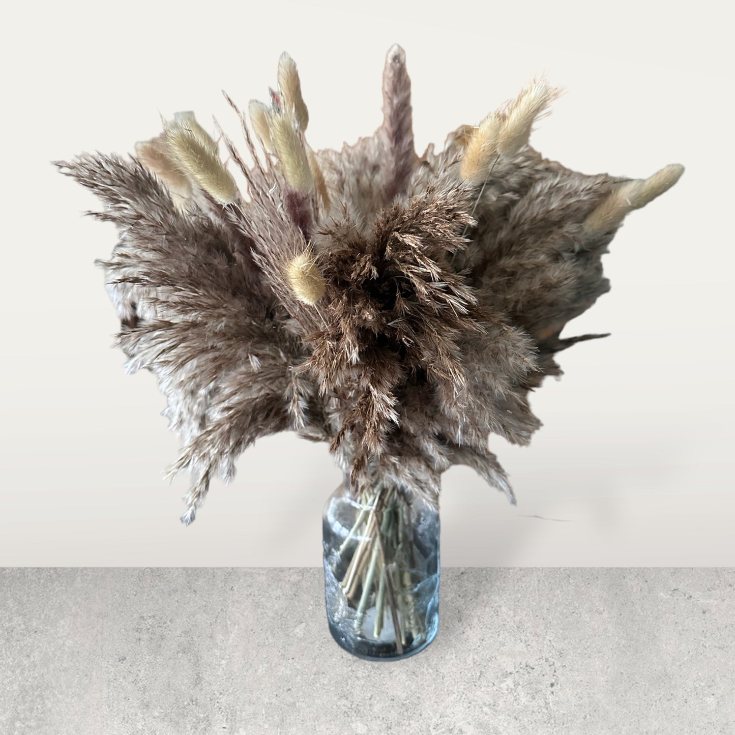 Dried floral arrangements with glass vase