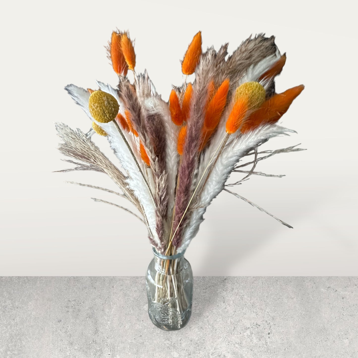 Dried floral arrangements with glass vase